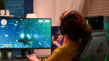 Joyful player celebrates victory winning space shooter online game on powerful personal computer. Online streaming cyber performing during gaming tournament using technology network wireless photo