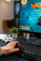Close up hand of pro gamer during online tournament using RGB keyword streaming space shooter game photo
