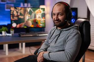 Winner gamer playing shooter videogames wearing virtual reality headset during championship. Virtual online streaming cyber performing game tournament using technology network wireless photo