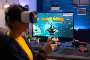 Winner gamer playing space shooter videogames wearing virtual reality headset during championship. Virtual online streaming cyber performing during game tournament using technology network wireless photo