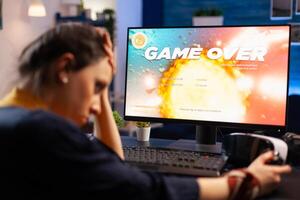 Caucasian gamer losing space shooter videogame competition on professional powerful computer. Professional pro gamer streaming online game with new graphics using modern equipment photo