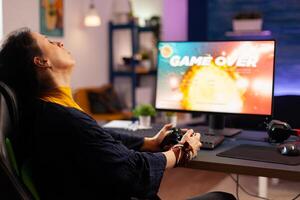 Player woman winning space shooter game using virtual reality goggles playing games with modern joystick. Professional gamer streaming online videogames with new graphics on powerful computer photo