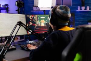 Pro woman gamer with headphone streaming videogames in gaming home studio. Professional player talking with other players online for game competition playing on powerful computer photo