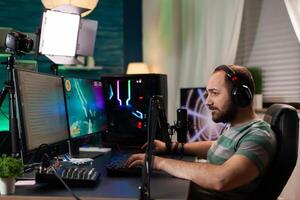 Competitive player streaming esport tournament using technology network wireless Competitive woman playing online space shooter competition on powerful professional computer talking into microphone photo