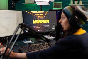 Streamer woman winning virtual videogame competition use professional equipment in home studio. Online streaming cyber performing during gaming tournament using technology network wireless photo