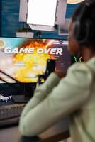 Black viodeo games esports streamer with headphones losing live championship. Professional gamer streaming online games with new graphics on powerful computer. photo