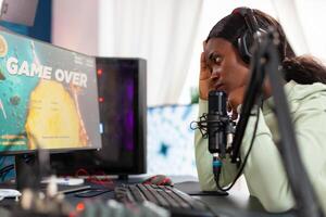 African esport streamer being upset losing game championship. Professional gamer streaming online games with new graphics on powerful computer. photo