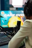 Afro streamer losing online championship being disappointed game over. Professional gamer streaming online games with new graphics on powerful computer. photo
