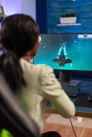 Professional esports gamer player during online championship with joystick. Competitive cyber player woman performing videogame tournament use professional joystick. photo