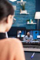 Caucasian female chatting with her math teacher during university videocall conference using laptop cumputer. Student working at communication lesson while sitting at desk in living room photo