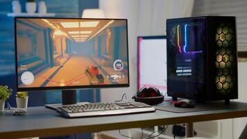 Professsional gaming empty room studio with neon lights and RGB powerful computer, keyboard and mouse. FPS shooter game on pc display, stream chat on television photo