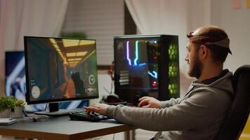 Pro esport man gamer smiling at camera playing first person shooter game gaming on virtual championship event. Online streaming cyber performing on powerful personal computer during tournament photo