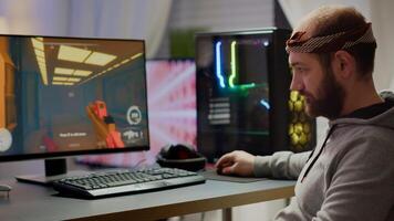 Professional esport man gamer looking at camera smiling while compete in videogame playing space shooter game. Online streaming cyber performing on powerful personal computer during gaming tournament photo