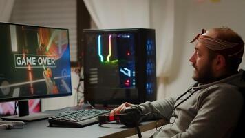 Angry pro gamer playing space shooter games and losing using RGB powerful computer. Gamer over of mock-up game player, performing in cyber room virtual game in cyberspace, gaming tournament photo
