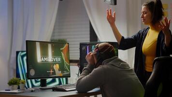 Professional couple of gamers losing first person shooter game playing on powerful personal computer for online championship. Sad cybers performing in gaming room during virtual tournament photo