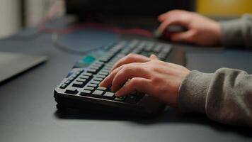 Close-up on hands of pro cyber man playing game using RGB keyboard. Virtual championship in cyberspace, esports player performing on powerful computer during online esports gaming tournament photo