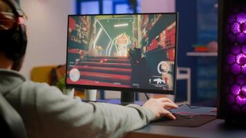 Gamer man with professional headphones relaxing in gaming room playing shooter game on powerful computer. Virtual championship in cyberspace, esports player performing in gaming tournament photo