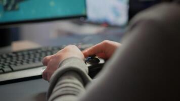 Close up on hands of game r playing using wireless joystick in cyberspace sitting on gaming chair. Cyber man holding controller performing space shooter games at online esports championship photo