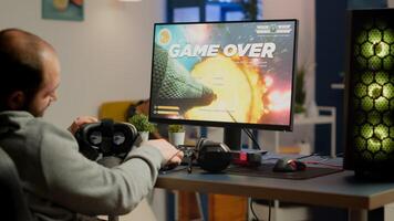 Videogamer losing graphics cyberspace game sitting on gaming chair using wireless controller and VR headset playing on powerful computer. Sad pro cyber man streaming online championship photo