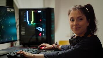 Concentrated gamer looking at camera while playing space shooter online game on RGB powerful personal computer during egames championship. Esport cyber performing during gaming tournament photo