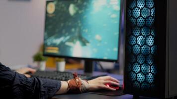 Close up of gamer using professional RGB mouse and keypad playing space shooter tournament in gaming home studio. Pro player streaming online game during virtual championship on powerful computer photo