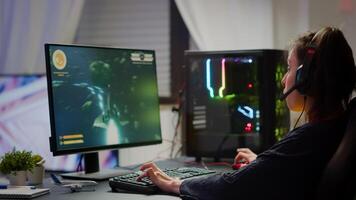 Excited professional esport gamer celebrating championship victory, woman winning space shooter game. Pro cyber gaming online tournament live streaming championship using RGB powerful computer photo