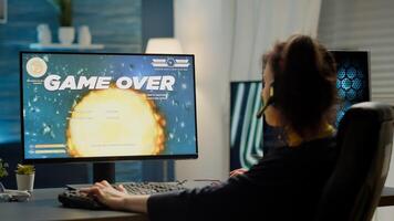 Sad pro woman gamer with headset losing games streaming space shooter game from gaming studio. Game over for cyber player performing online cybersport competition using powerful computer photo