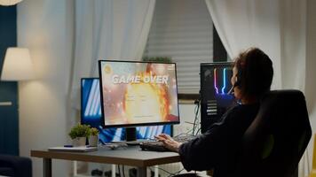 Furious pro woman gamer with headset losing space shooter game with new graphics during gaming championship playing from home at RGB powerful personal computer, performing at esports tournament photo