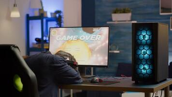 Angry pro woman gamer losing space shooter game during online championship. Cyber player testing virtual games using powerful personal computer in gaming room during esports tournament photo