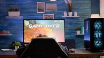 Upset professional woman gamer wearing headset losing space shooter game in cybersport competition. Tired pro cyber player gaming online games on powerful personal computer with RGB lights. photo