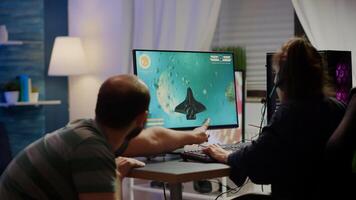 Nervous couple of cyber players screaming losing space shooter game during gaming tournament playing on powerful personal computer wearing professional headset performing in cybersport competition photo