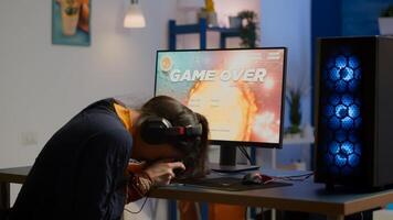 Pro woman gamer losing space shooter game competition on professional powerful computer with wireless controller. Professional player streaming online game using professional joystick and headset photo