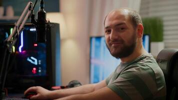 Focused streamer gamer looking at camera preparing streaming space shooter online game playing on RGB powerful computer during egames championship. Esport cyber performing in gaming tournament photo
