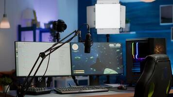 Empty gaming studio with RGB led lights powerful personal computer for streaming online competition. Display with stream chat prepared for virtual tournament, living room with nobody in photo