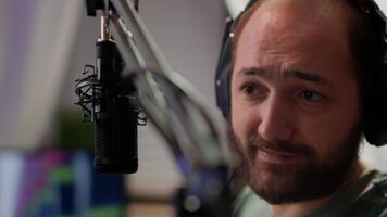Close up of pro streamer sitting on gaming chair discussing with players at professional micorphone playing space shooter game during online tournament. Portrait of cyber talking on stream chat photo