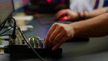 Close up of professional keyboard with RGB lighting streaming at chat. Player using powerful gaming computer in home studio of esport game typing at keypad playing space shooter videogame. photo
