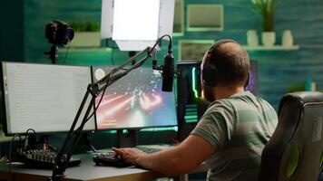 Man streamer playing space shooter videogame using headset, talking on stream chat and microphone. Online streaming cyber performing on RGB powerful professional computer during gaming tournament photo