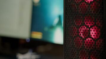 Close up of RGB system desktop prepared for e sport online tournament. Powerful personal computer for online videogames with space shooter game on screen. Cozy gaming room with modern design photo