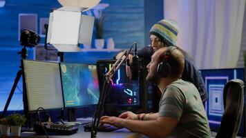 Excited players couple winning online videogames competition using powerful computer celebrating victory. Streamer gamer playing games with RGB keyboard performing at gaming turnament photo