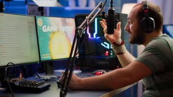 Nevous streamer losing videogame, game over for man cyber playing online space shooter games with headset. Player performing on powerful computer talking with players on chat in gaming competition photo
