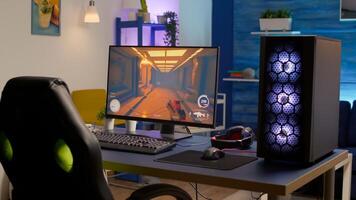 Empty gaming romm with RGB professional keyboard, mouse and headset. Pro gamer using powerful computer for first person shooter tournament late at night in home studio photo