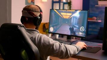 Cyber gamer stretching hands and neck before playing online games using RGB keyboard and mouse. Player performing online games during gaming tournament photo