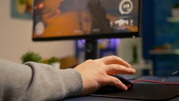 Close up of gamer using professional mouse playing first person shooter tournament. Pro player using RGB equipment during online championship late at night in gaming studio photo