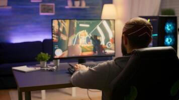 Pro gamer playing first person shooter game at gaming home studio using RGB mouse keyboard. Virtual online streaming setup with neon lights cyber performing during game tournament photo