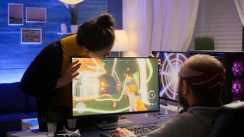 Cyber gamer fight with girlfriend about playing first person shooter game for online competition. Pro player performing on powerful pc in gaming room home during online tournament photo