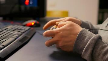 Close-up of wireless joystick during online championship in gaming hone studio. Competitive player man playing game tournament with new graphics using professional RGB equipment photo