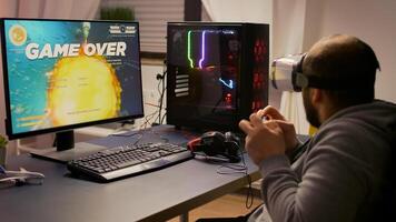 Pro player with headphones losing game with modern graphics for first person shooter online championship. Digital gamer using joystick for gaming competition late at night in living room. photo