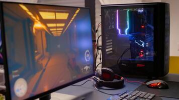 Close-up of professional monitor with first person shooter game on. Home studio of esport game player using powerful gaming computer during online competition photo