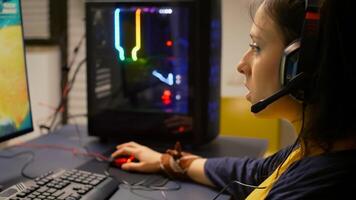 Competitive player using RGB equipment for live championship, playing on professional powerful computer. Online streaming cyber performing during gaming tournament using technology network wireless photo