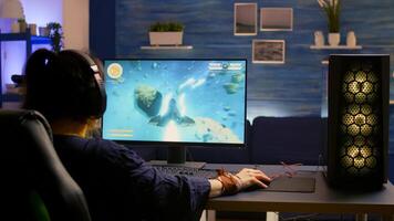 Esport game r wearing headset and playing online game for space shooter championship. Online streaming cyber performing gaming tournament using modern technology network wireless photo